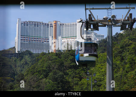 Overhead cable car with office buildings in the background, Genting Highlands, Malaysia Stock Photo