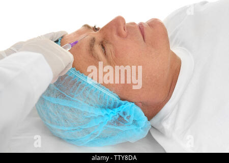 Senior man having correction injection on white background Stock Photo