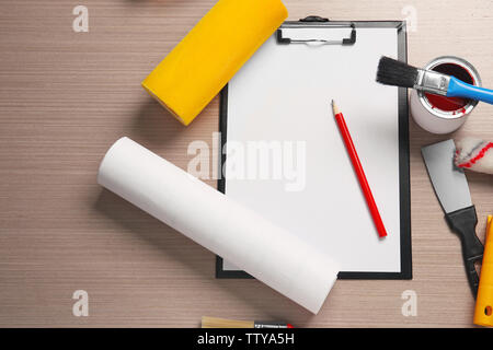 Clipboard and decorator instruments on wooden table Stock Photo