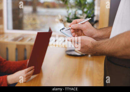Closeup of waiter taking order in cafe Stock Photo
