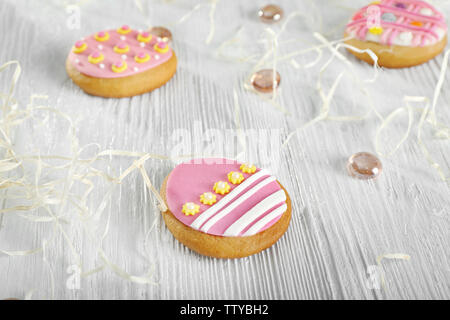 Creative Easter cookies and decorations on wooden table, closeup Stock Photo