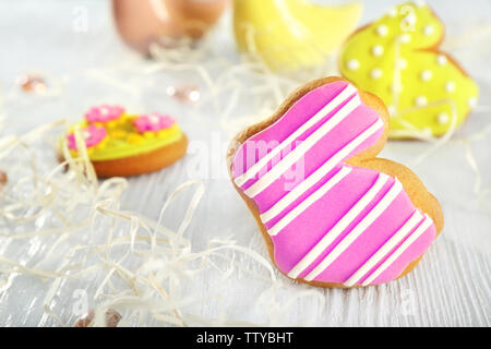 Creative rabbit shape Easter cookie and decorations on wooden table, closeup Stock Photo