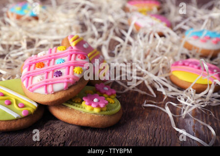 Creative Easter cookies and decorations on wooden table, closeup Stock Photo