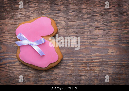 Creative rabbit shape Easter cookie on wooden background Stock Photo