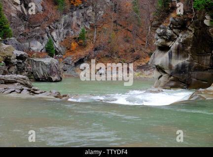 Mountain river flowing through autumn forest Stock Photo
