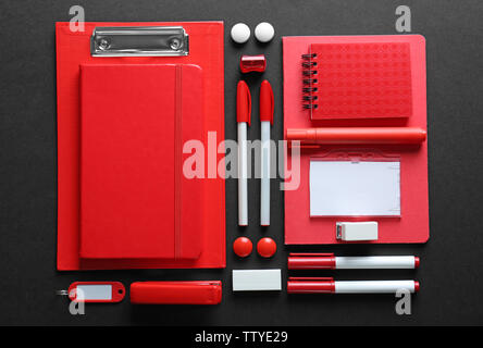 Flat lay of red stationery on black background Stock Photo