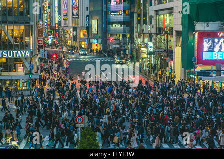 Tokyo, Japan - April 5, 2018: Shibuya Crossing, a world famous and iconic intersection in Shibuya, Tokyo. Hundreds of people from all directions at on Stock Photo