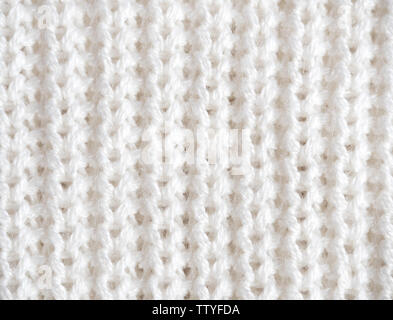 Knitted loops background. Part knitted sweater. Knitted texture. White Knitted Fabric Texture. White knitting wool texture background. Wool sweater Stock Photo