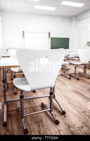 Closeup student chair seat and desk in classroom background with on wooden  floor. Education and Back to school concept. Architecture interior. Social  Stock Photo - Alamy