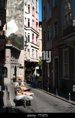 Traditional Turkish Eskici in Cihangir, the old man pushes a cart around the trendy Istanbul neighborhood collecting antiques and other old odds and e Stock Photo