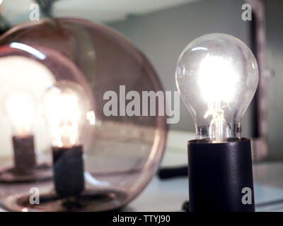old light bulb glowing in dark. Light bulbs shining. Stock Photo