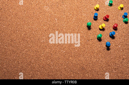 cork board with colored pins on it Stock Photo