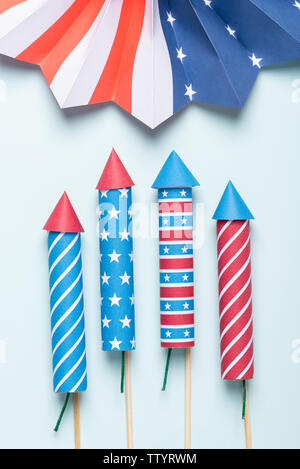 Independence day USA flag style fireworks and paper fan on blue background Stock Photo