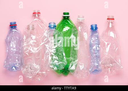 Plastic bottles on pink pastel background top view. Eco plastic recycling concept. Stock Photo