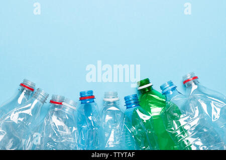 Plastic bottles recycle border on blue background with copy-space. Stock Photo