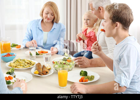 Happy family having lunch in kitchen Stock Photo