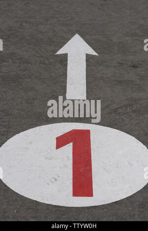Number 1 one and arrow painted on concrete road Stock Photo