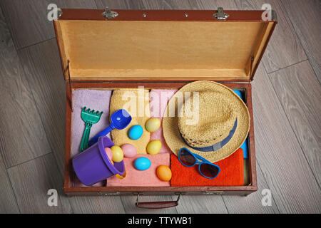 Easter eggs with open suitcase on floor Stock Photo