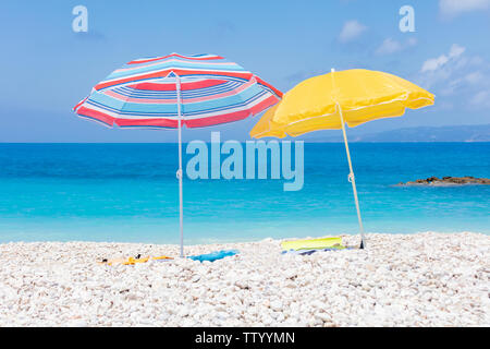 Two umbrellas with bedding on the white beach Stock Photo