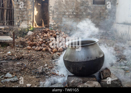 A big pot of water being boiled over an open fire Stock Photo