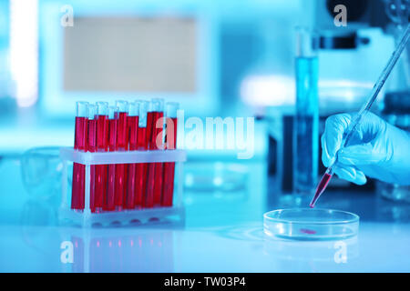 Scientist hand and test tubes with blood in laboratory Stock Photo