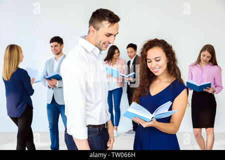 Young man and woman discussing book in club Stock Photo