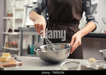 Young woman cooking in kitchen Stock Photo