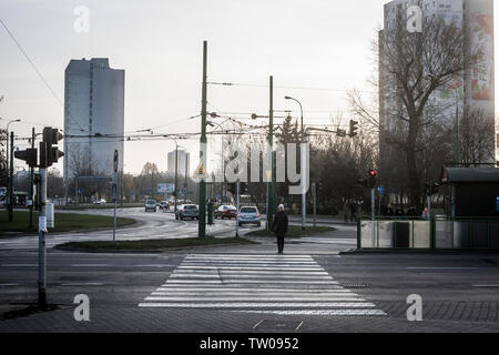 A woman waits to cross the road in Poznan, Poland Stock Photo