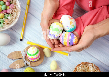 Mother and daughter holding decorated Easter eggs Stock Photo
