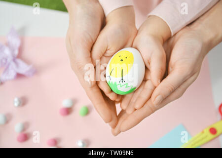 Mother and daughter holding decorated Easter egg Stock Photo