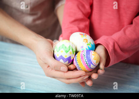 Mother and daughter holding decorated Easter eggs Stock Photo