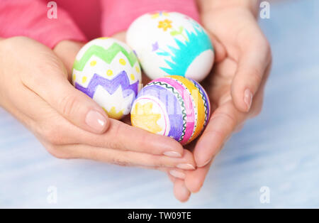 Mother and daughter holding decorated Easter eggs Stock Photo