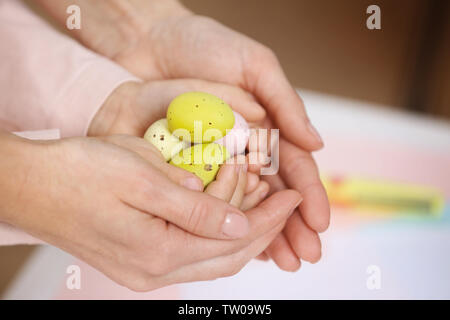 Mother and daughter holding decorated Easter eggs Stock Photo