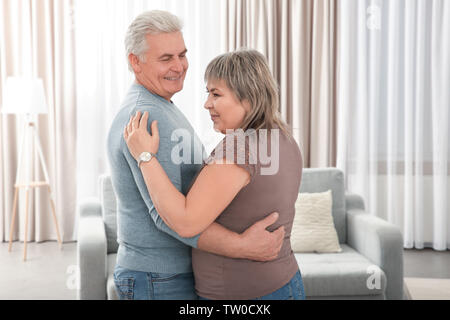 Middle aged couple dancing in the room Stock Photo