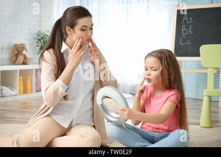 Young woman teacher and little girl on private lesson Stock Photo