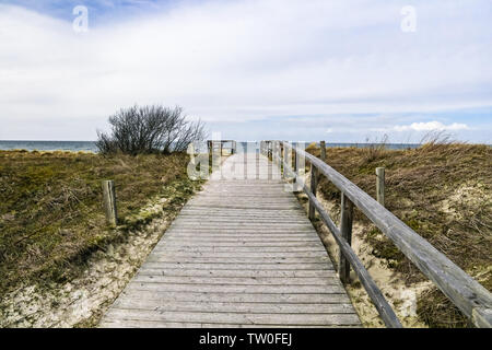 Wooden path at Baltic sea over sand dunes with ocean view Stock Photo