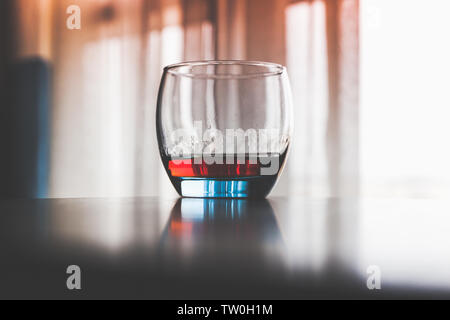 Glass of cognac stands on a desk in bar Stock Photo