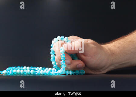 Male hand holding beads Stock Photo