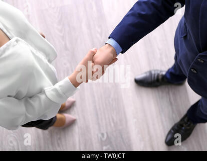 Business handshake against wooden floor background Stock Photo