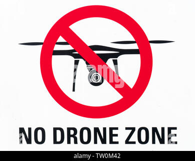 Horizontal view of an illustration sign prohibiting the use and flying of drones with written warning of 'no drone zone' in English Stock Photo