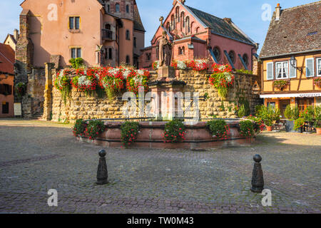 village Eguisheim, castle and well in the old town and tourist destination of the Alsace, France Stock Photo