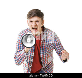 Protesting young man shouting into megaphone on light background Stock Photo
