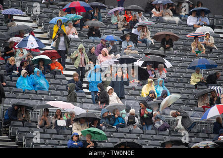 The Queens Club, London, UK. 18th June 2019. Day 2 of The Fever Tree Championships, rain cancels all play on Day 2 leaving spectators sheltering under umbrellas. Credit: Malcolm Park/Alamy Live News. Stock Photo