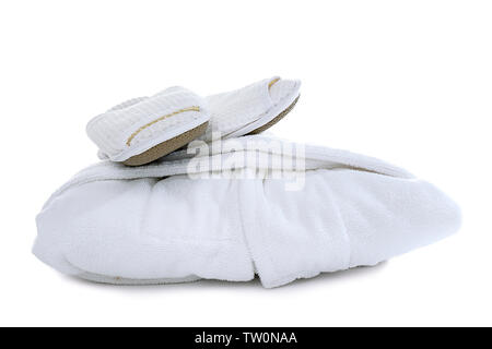 Folded spa bathrobe with slippers on white background Stock Photo