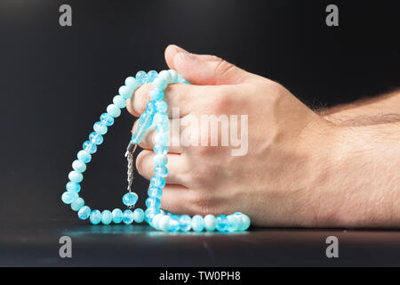 Male hand holding beads Stock Photo
