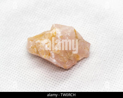 Geological specimen of natural pink layered mineral Rose quartz - semiprecious stone, on white background Stock Photo