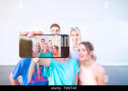 Group of young friends taking a selfie with mobile phone Stock Photo