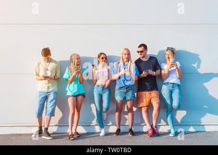 Group of young people using their mobile phones Stock Photo