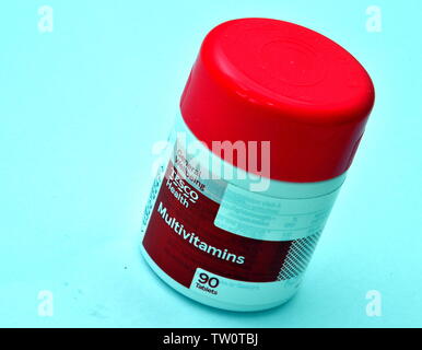A studio shot of a plastic tub of Tesco multivitamins and minerals food supplement on a white background Stock Photo