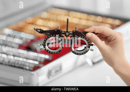 Doctor hand holding frame for trial lenses Stock Photo